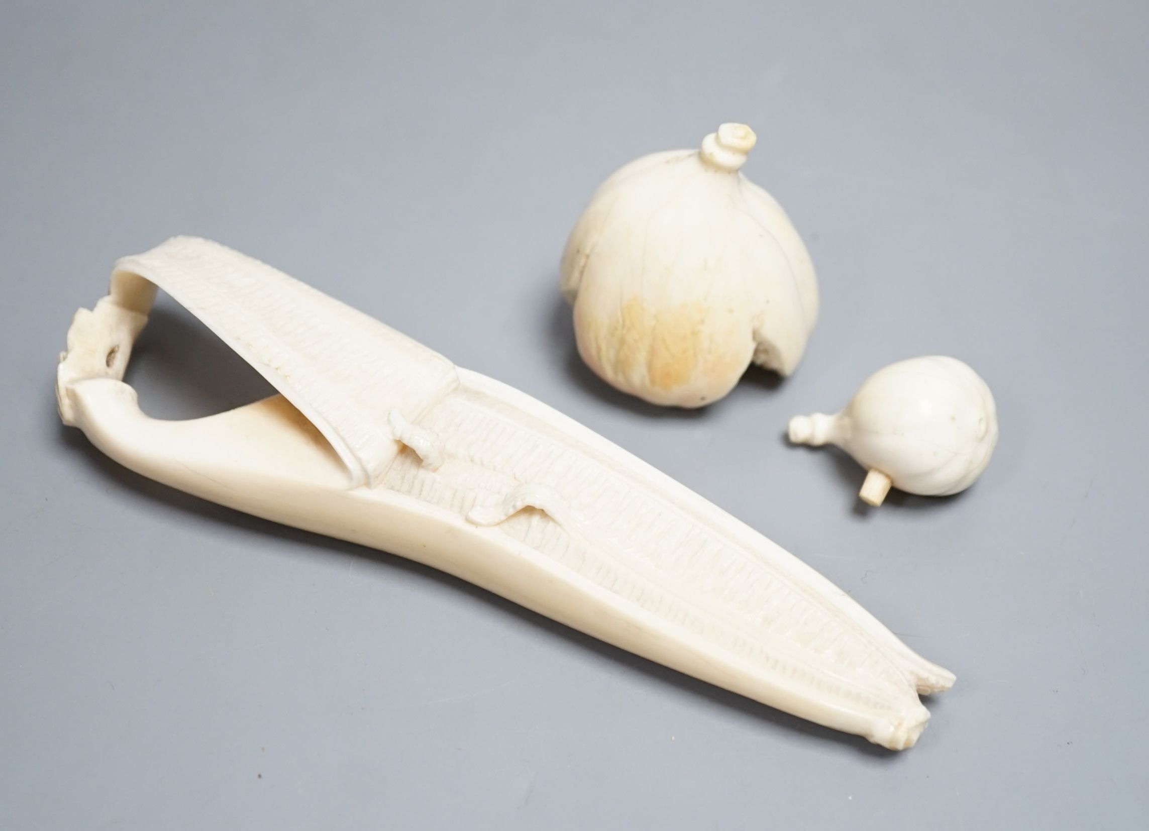 A Japanese ivory model of a partially peeled banana and an ivory model of figs, early 20th century (2) 15.5cm